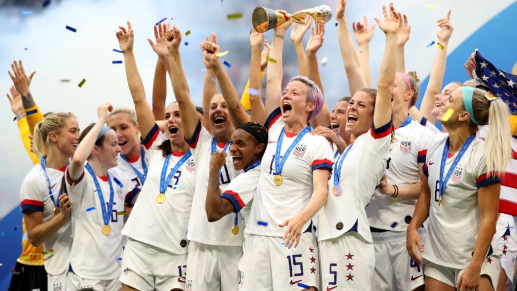 LYON, FRANCE - JULY 07: Megan Rapinoe and USA players celebrate as they lift the trophy during the 2019 FIFA Women's World Cup France Final match between The United States of America and The Netherlands at Stade de Lyon on July 7, 2019 in Lyon, France. (Photo by Marc Atkins/Getty Images)
